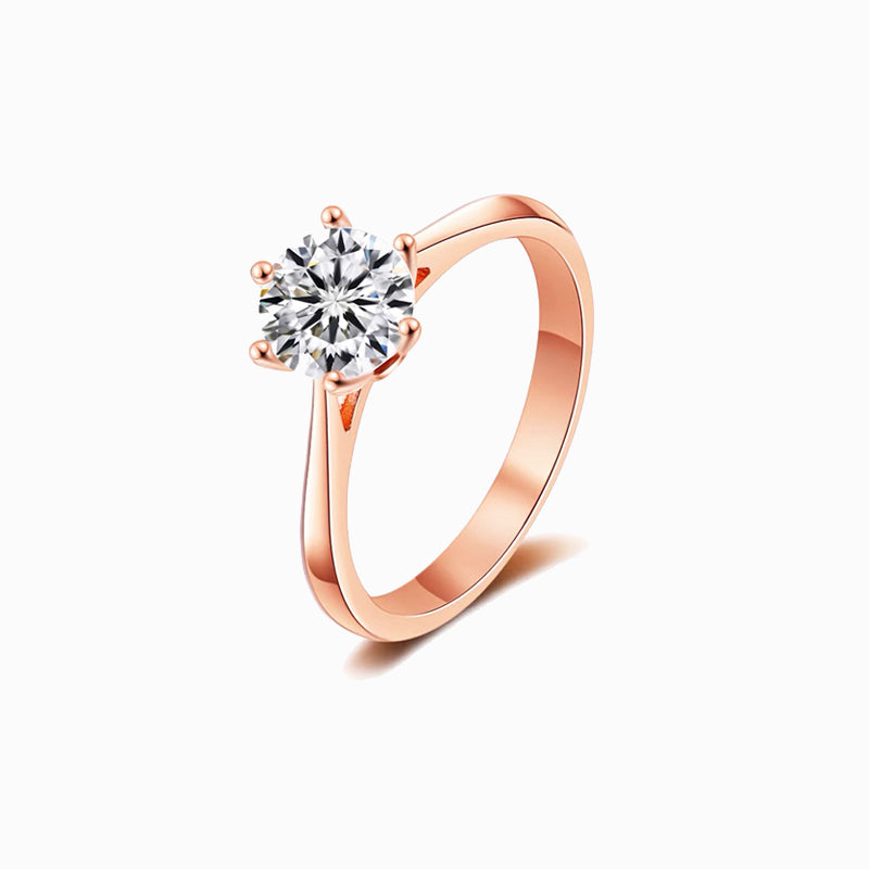 a rose gold ring with a single diamond
