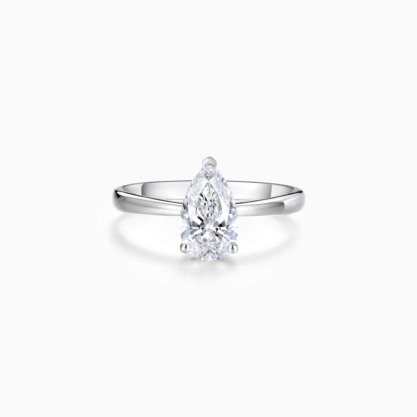 a pear shaped diamond ring on a white background