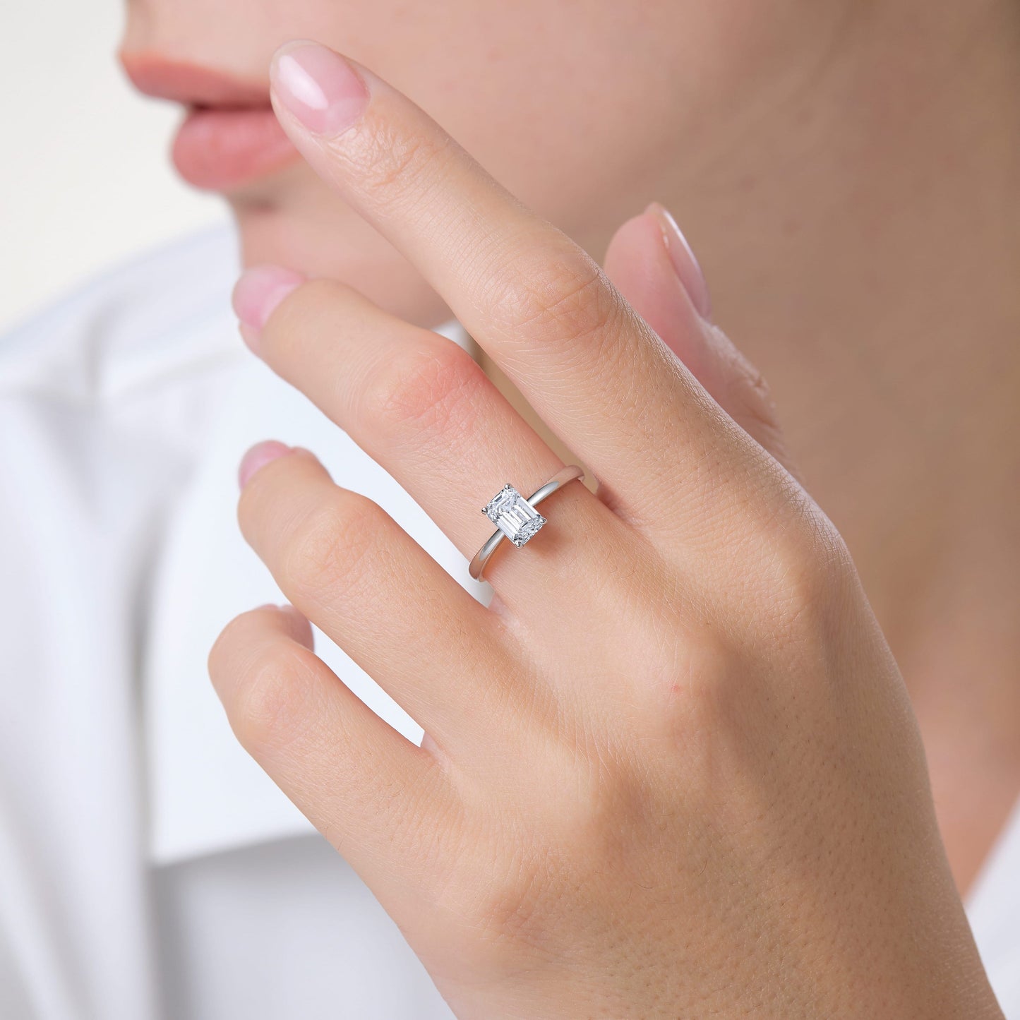 a woman wearing a diamond ring on her finger