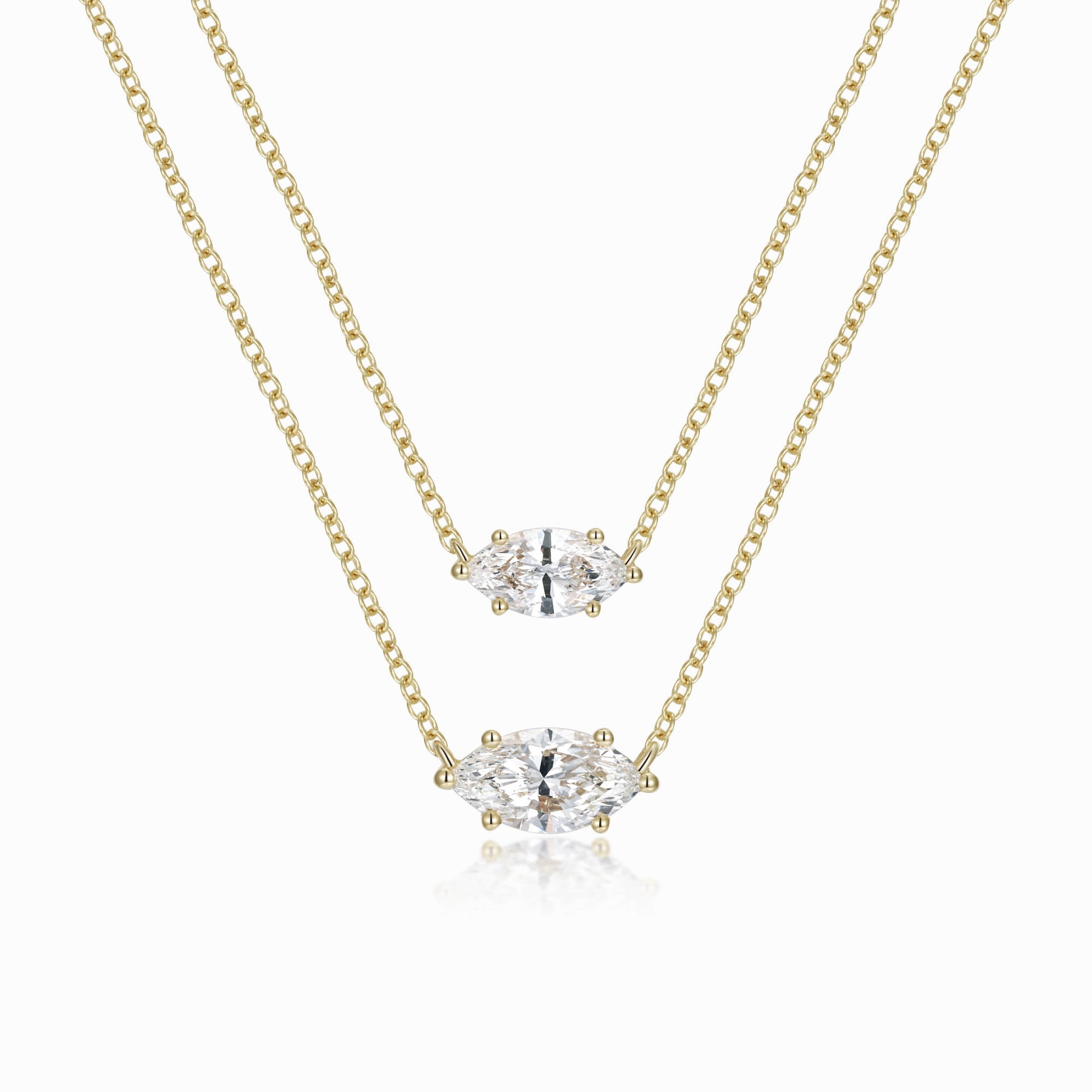 two pieces of gold chain with a diamond pendant