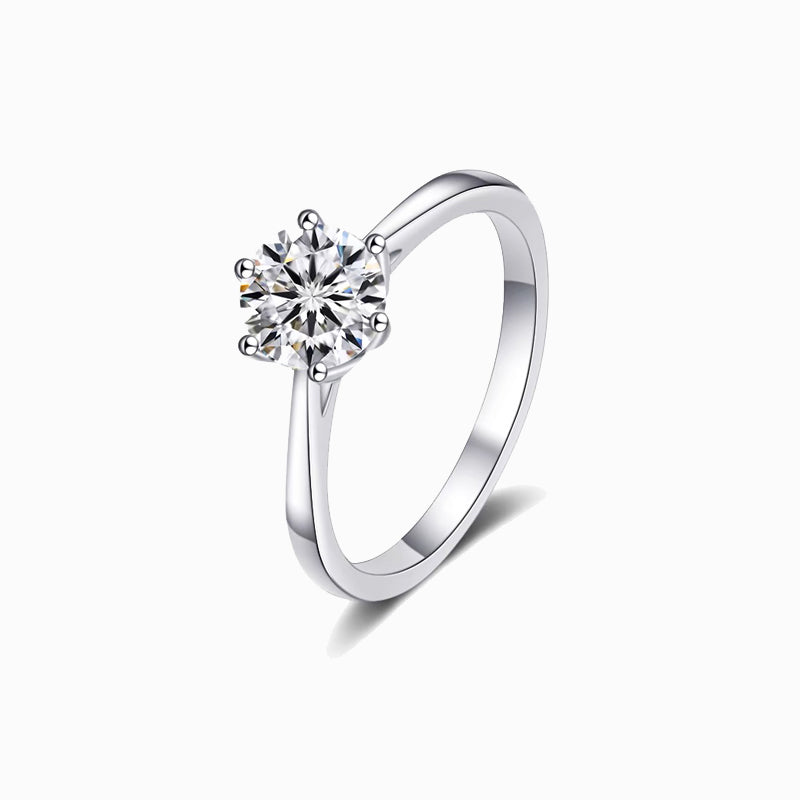 a white gold ring with a single diamond