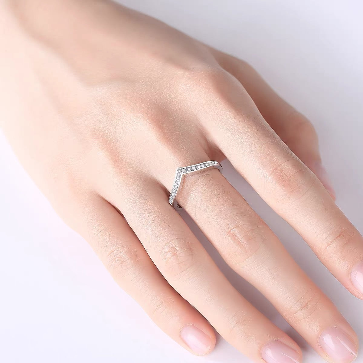 a woman's hand with a diamond ring on it