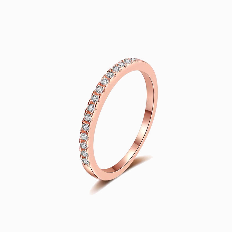 a rose gold ring with a row of diamonds