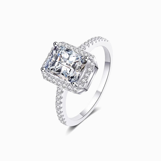 a white gold ring with a cushion cut diamond