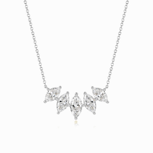 a silver necklace with three diamonds on it