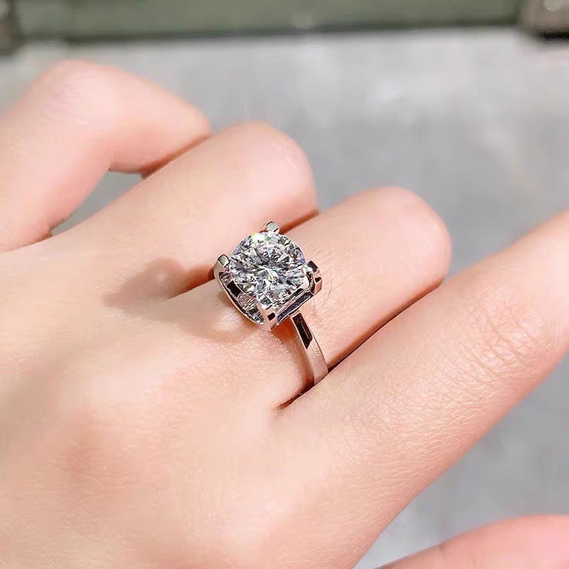 a woman's hand with a diamond ring on it