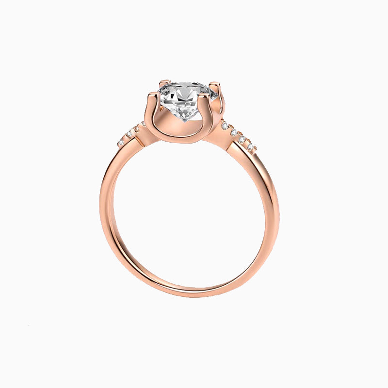 a rose gold ring with a white diamond