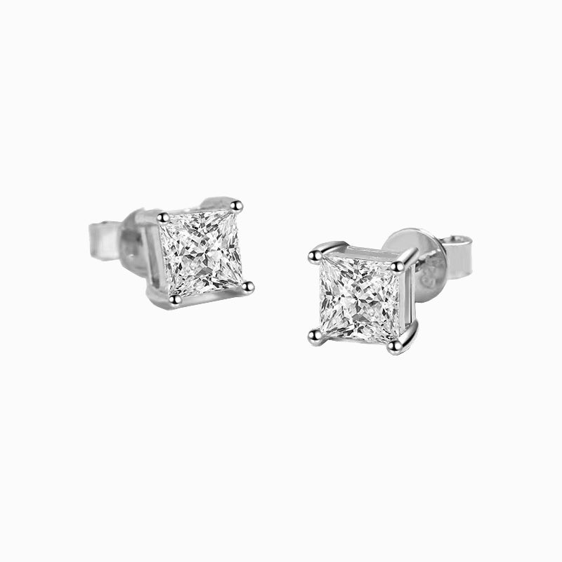 a pair of diamond earrings on a white background